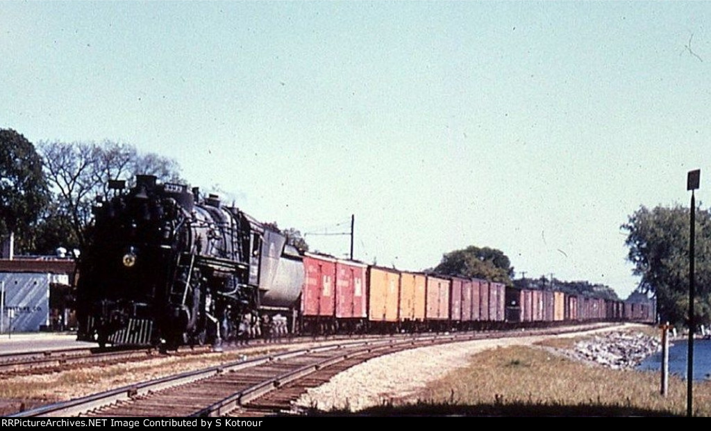 A Great Northern 2-8-2 in Wayzata MN 1957 by the depot.